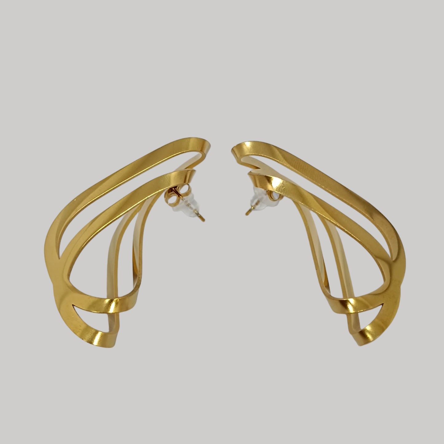 Gold hoop earrings on a light gray background