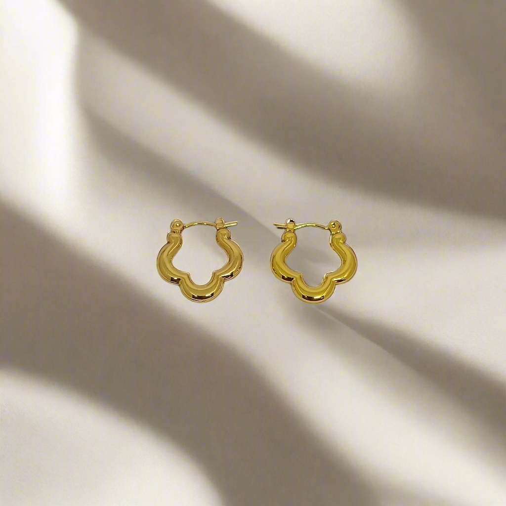 Golden hoop earrings on a white background