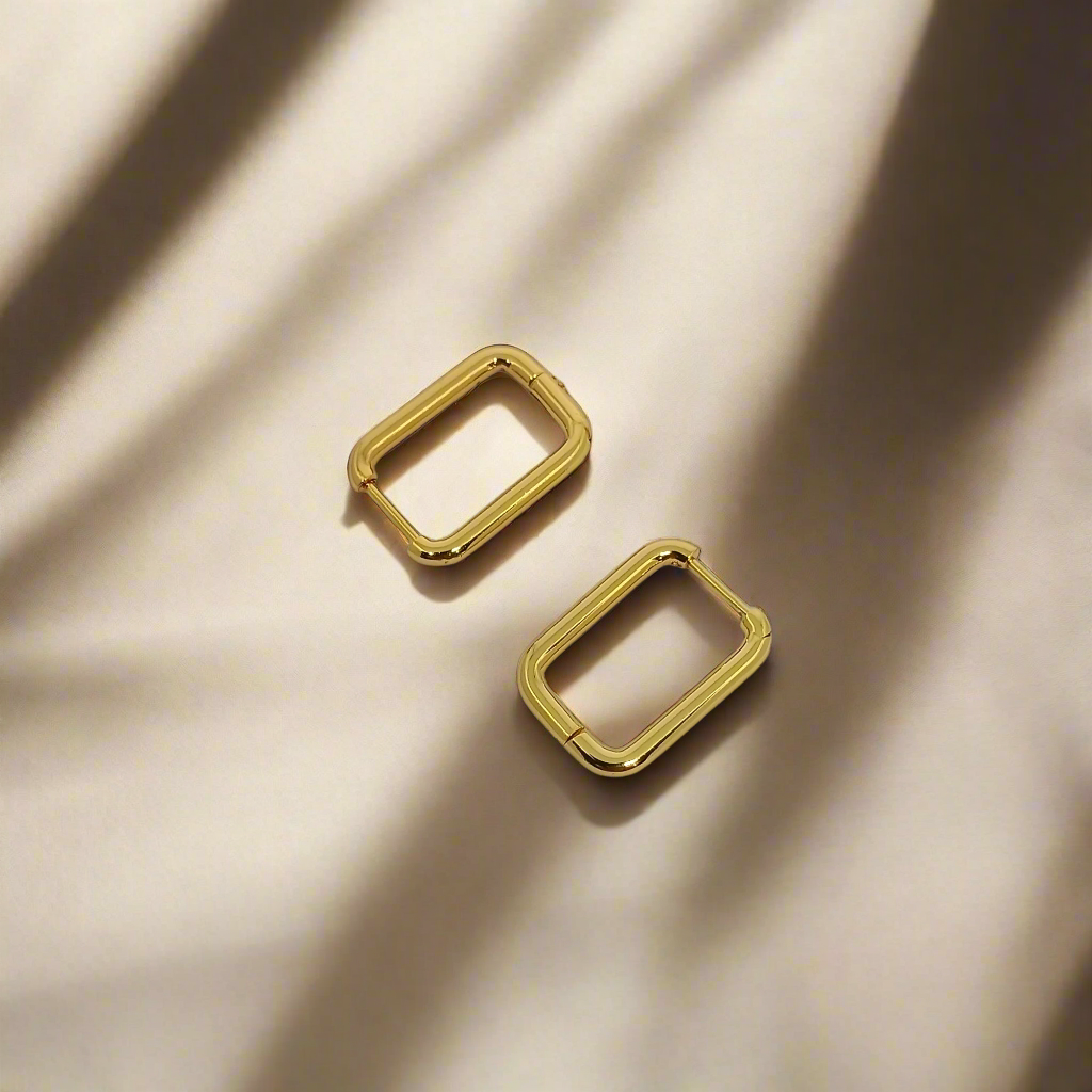 Gold square English lock earrings on a white background