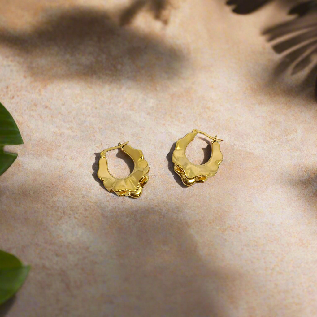 Gold hoop earrings on a white background