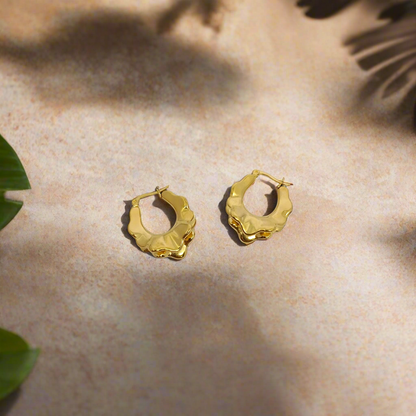 Gold hoop earrings on a white background