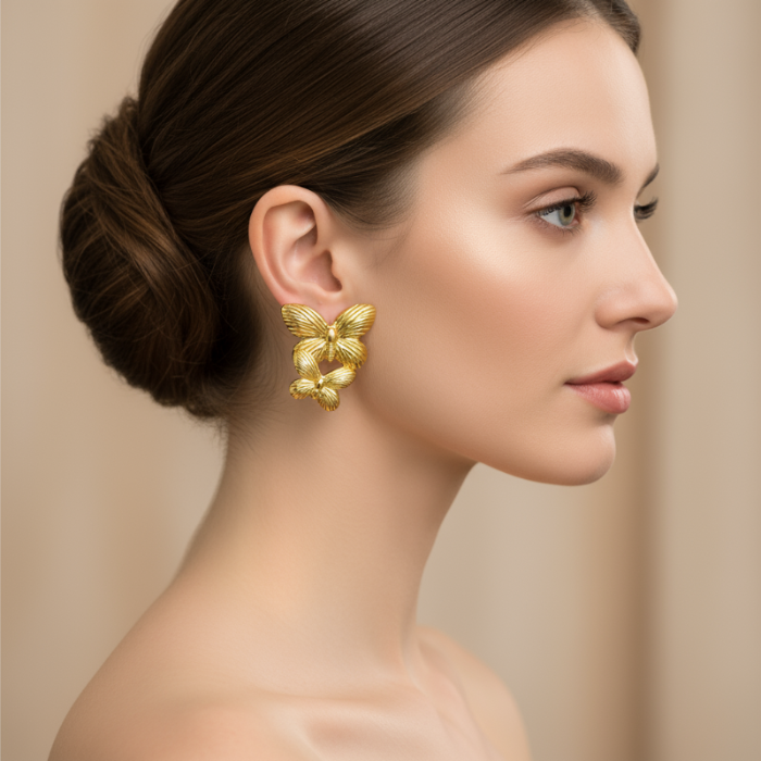 Woman wearing golden earrings against a beige background