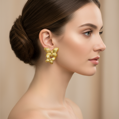 Woman wearing golden earrings against a beige background