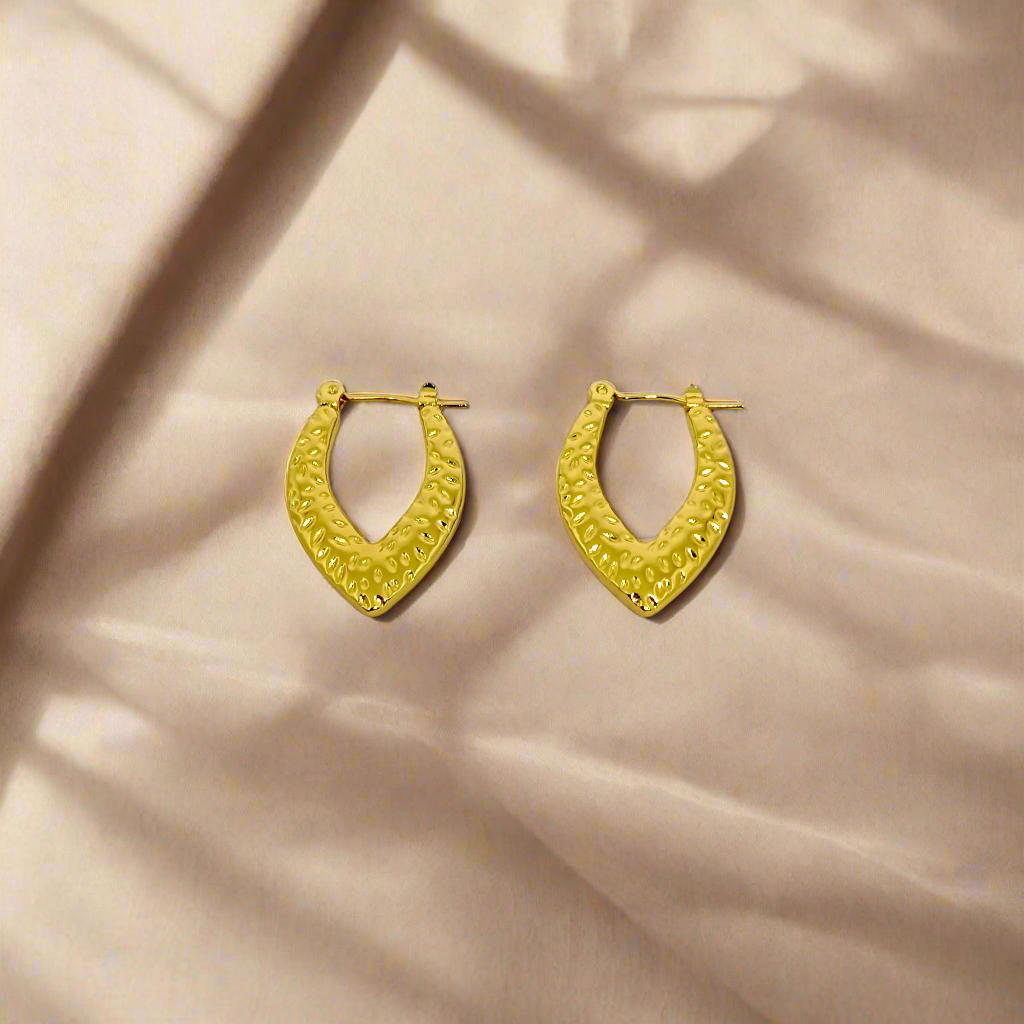 Gold hoop earrings on a white background