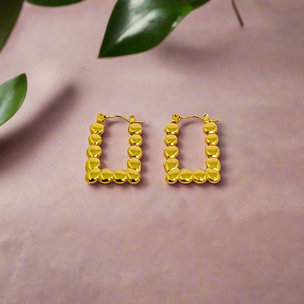 Gold hoop earrings on a white background