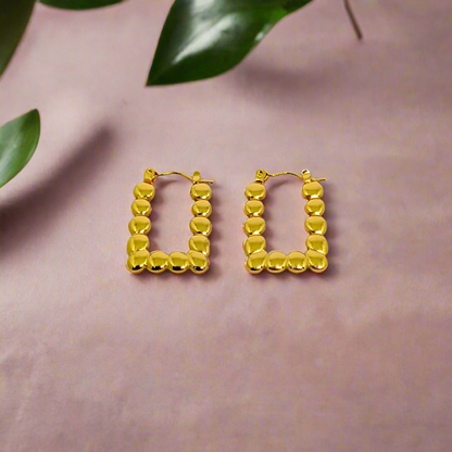 Gold hoop earrings on a white background