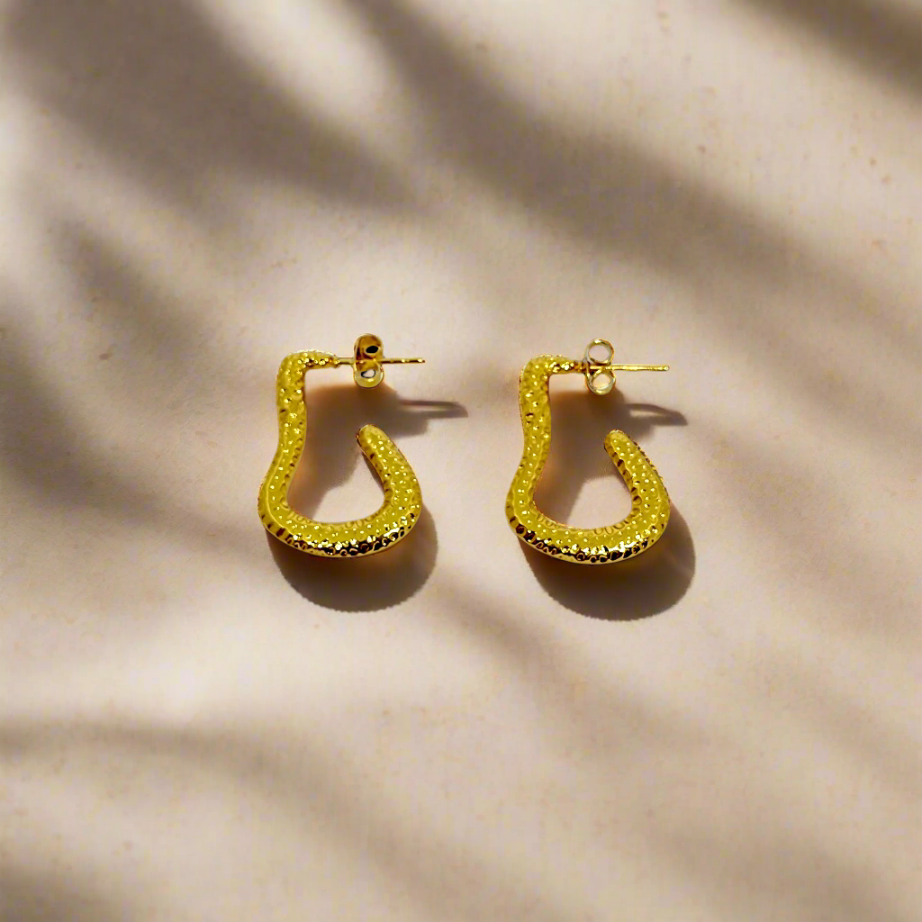 Gold hoop earrings on a white background