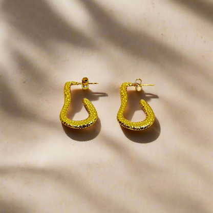 Gold hoop earrings on a white background