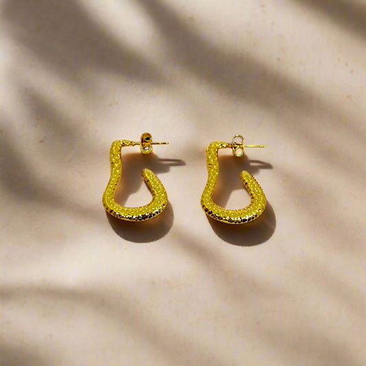 Gold hoop earrings on a white background