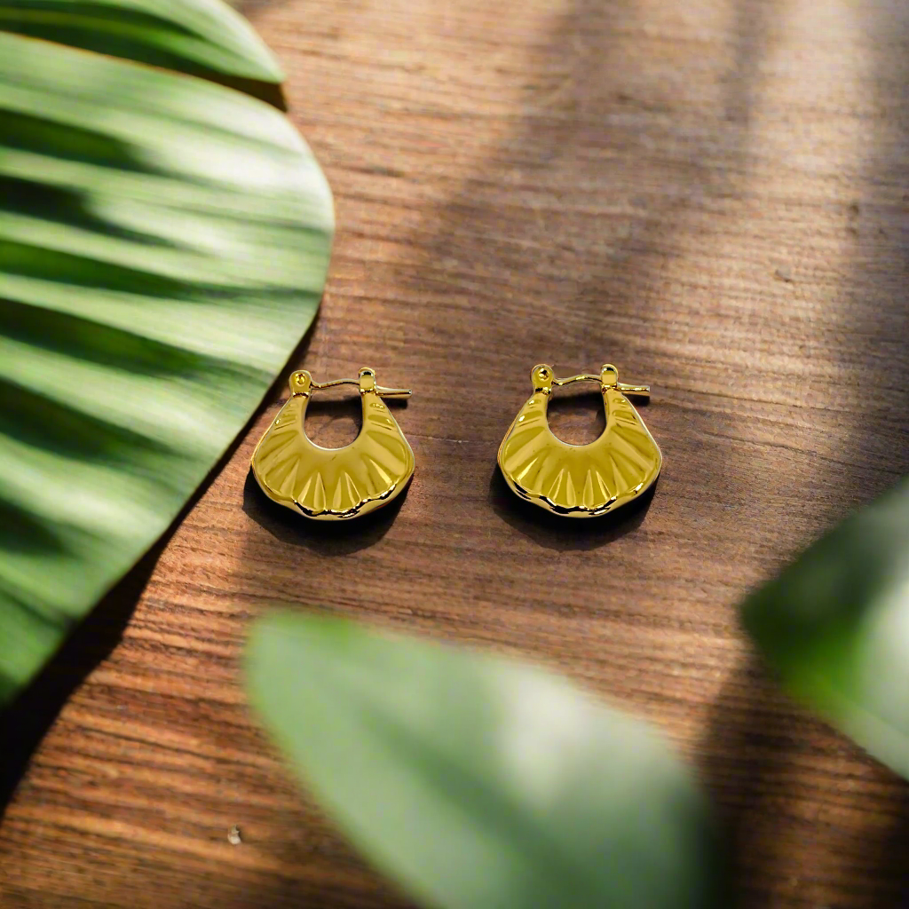 Gold hoop earrings on a white background