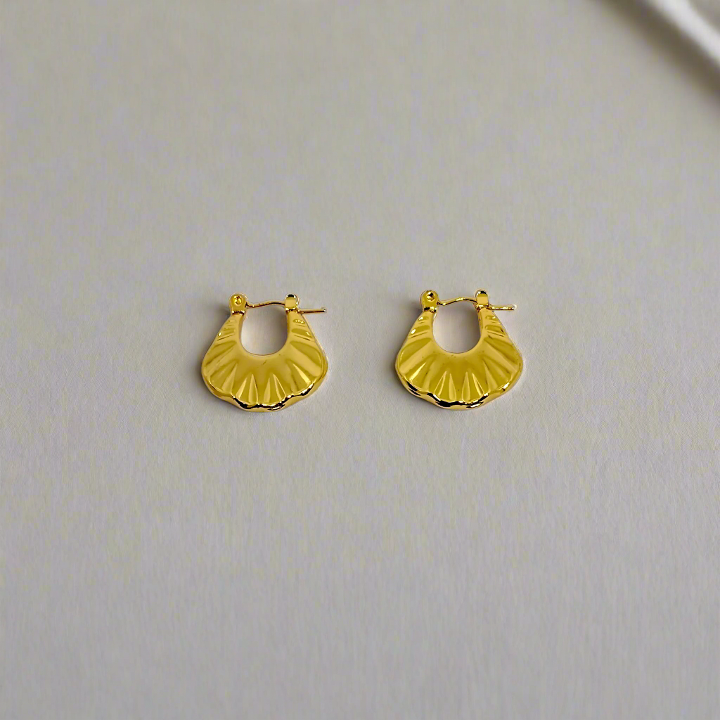 Gold hoop earrings on a white background