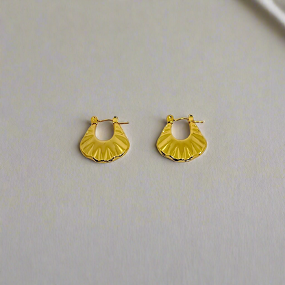 Gold hoop earrings on a white background