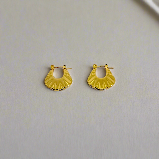 Gold hoop earrings on a white background