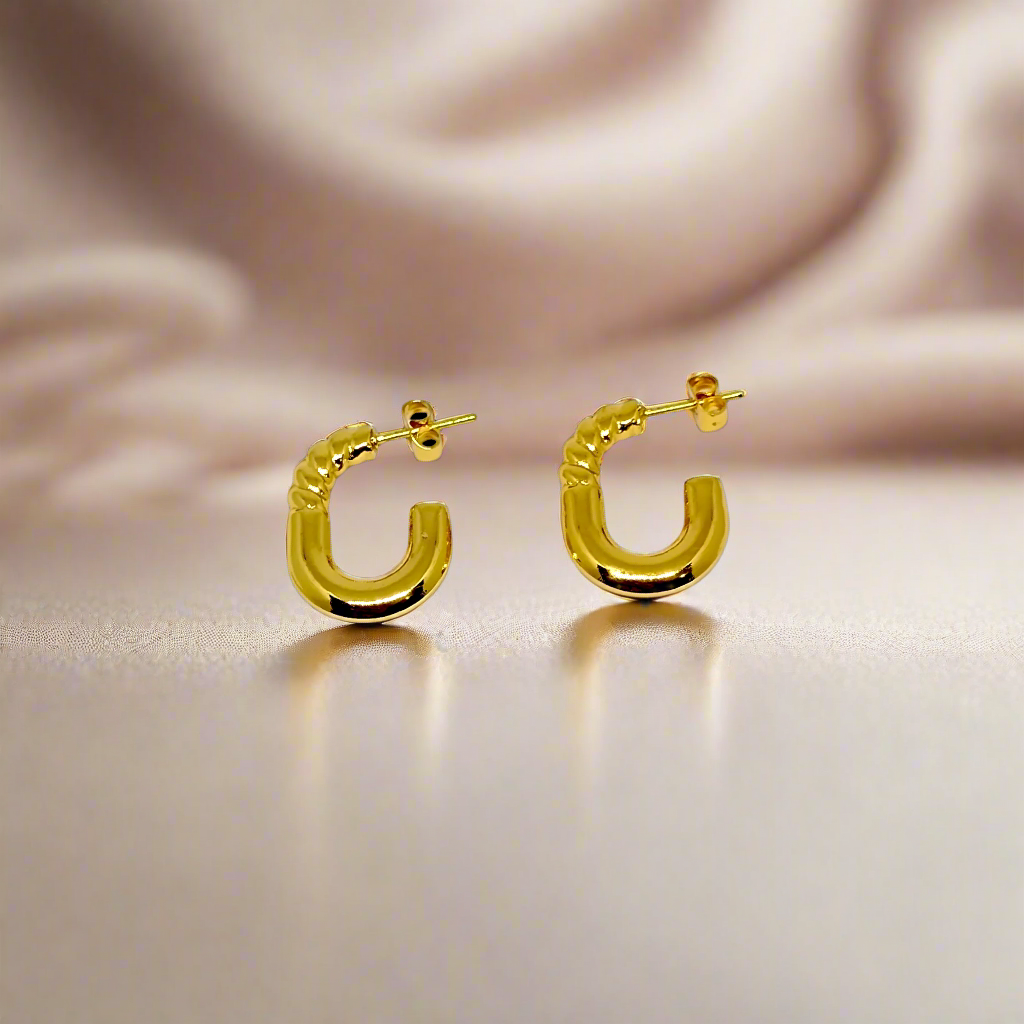 Gold hoop earrings on a white background