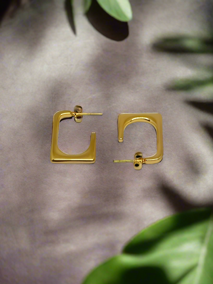 Gold hoop earrings on a white background