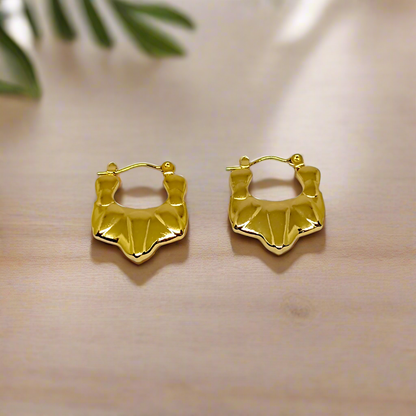 Gold hoop earrings on a white background