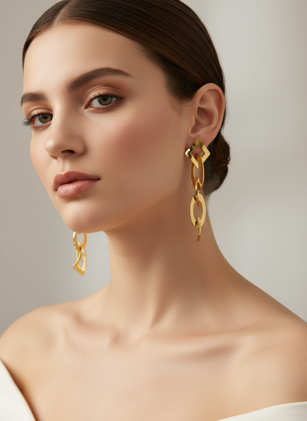 Woman wearing golden earrings with a neutral background