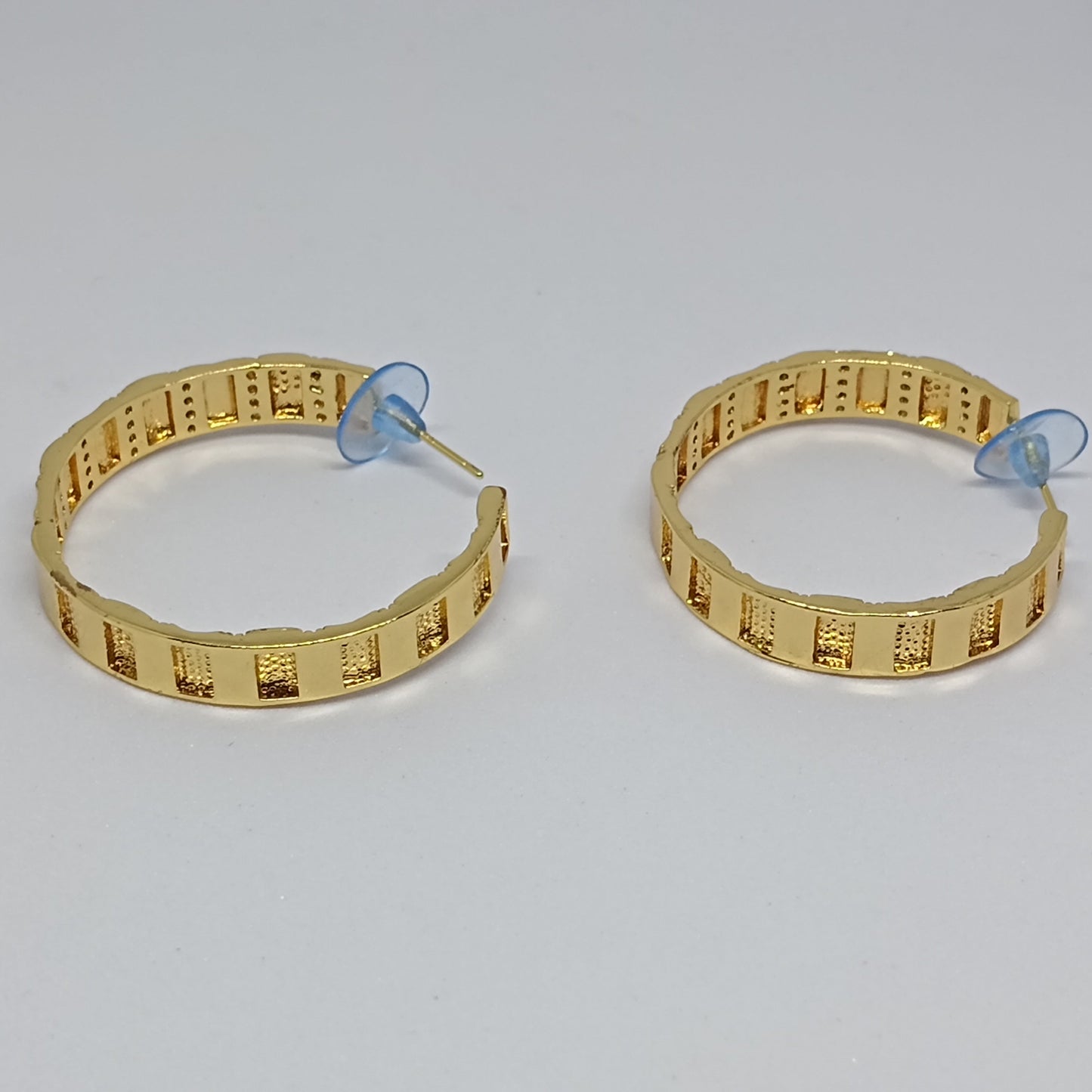 Pair of gold hoop earrings on a white background