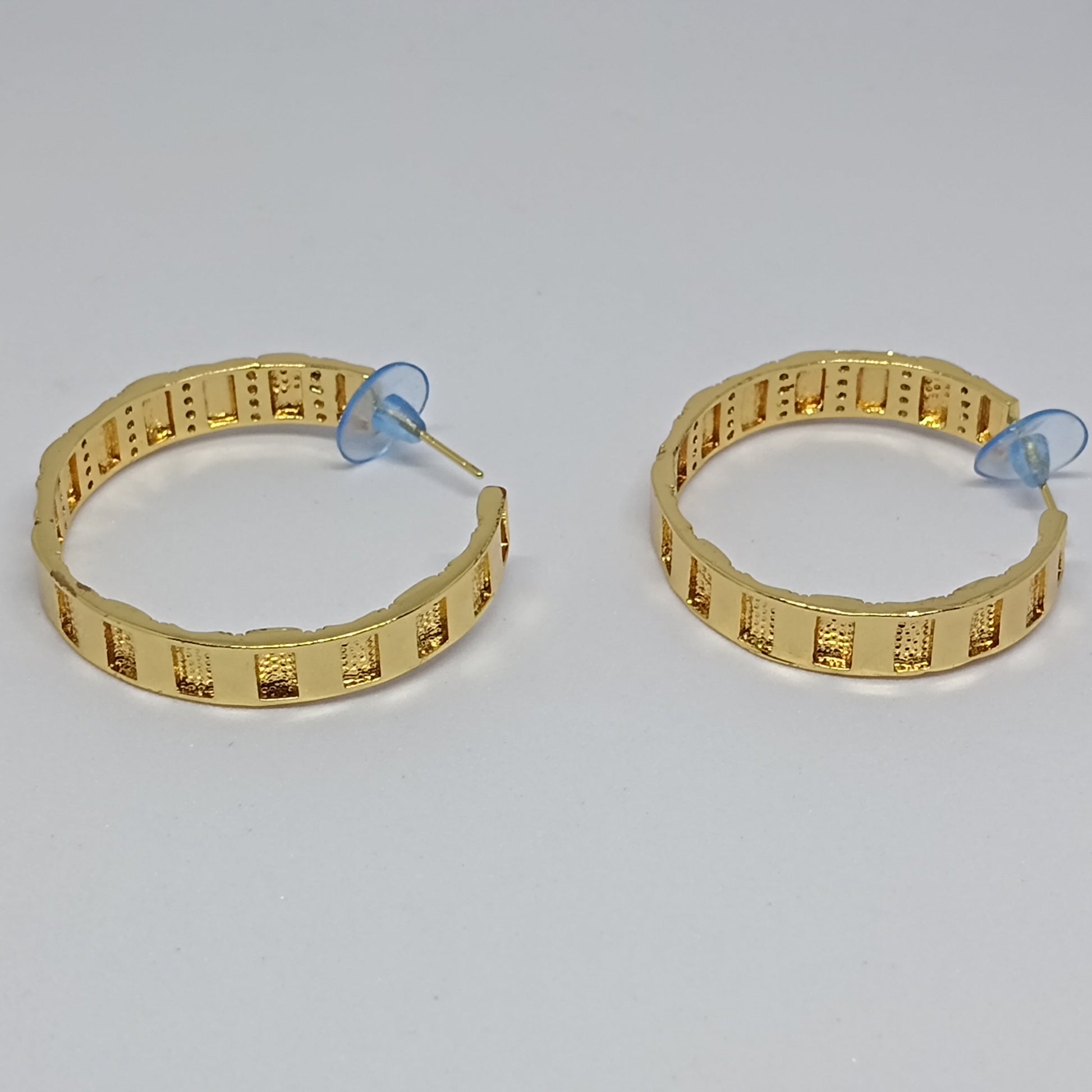Pair of gold hoop earrings on a white background