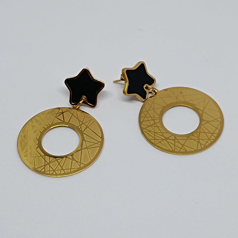Gold earrings with star and circular design on a white background