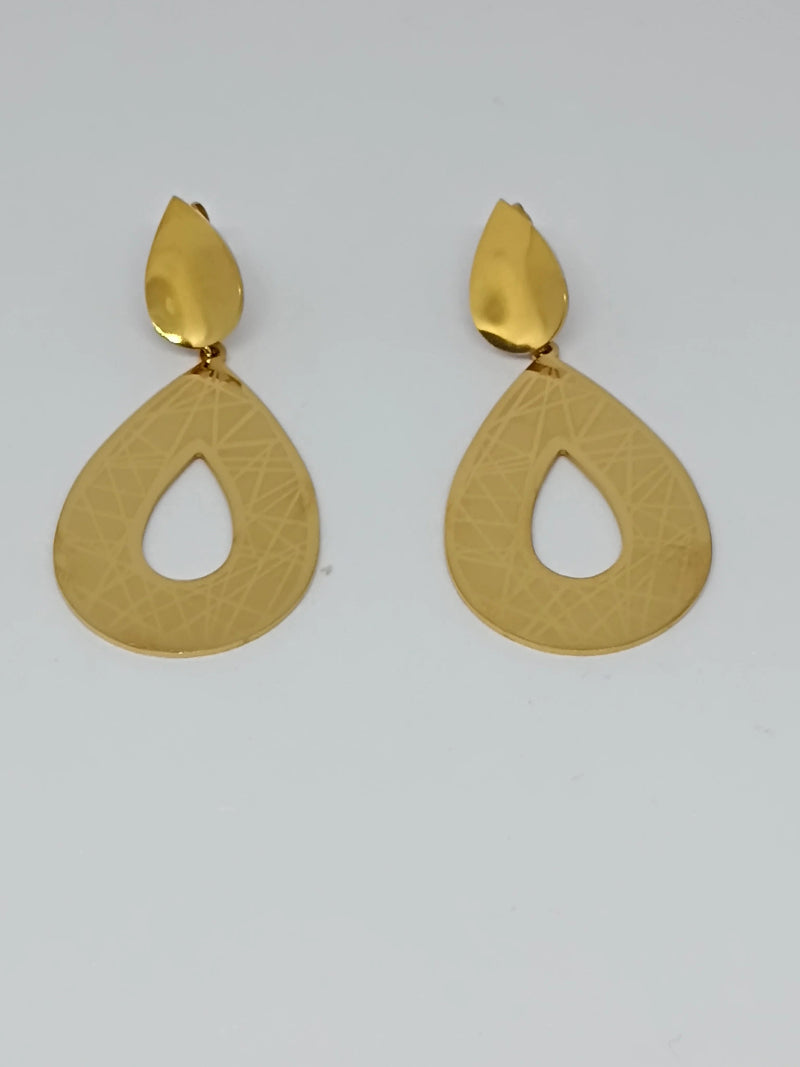 Pair of golden earrings on a light gray background