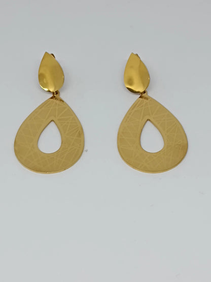 Pair of golden earrings on a light gray background