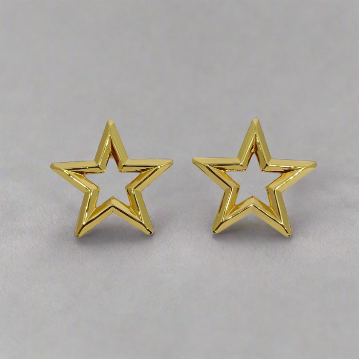 Gold star-shaped earrings on a light gray background