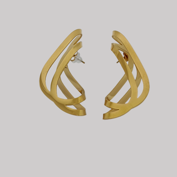 Gold earrings on a light gray background
