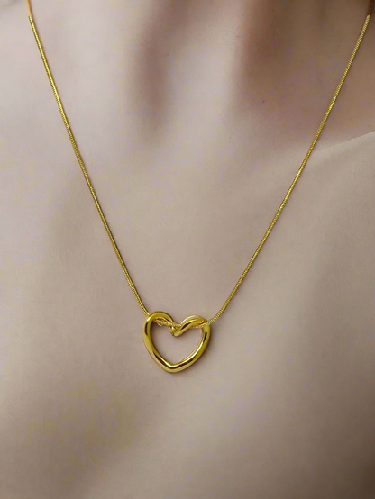 Gold heart-shaped necklace on a mannequin neck
