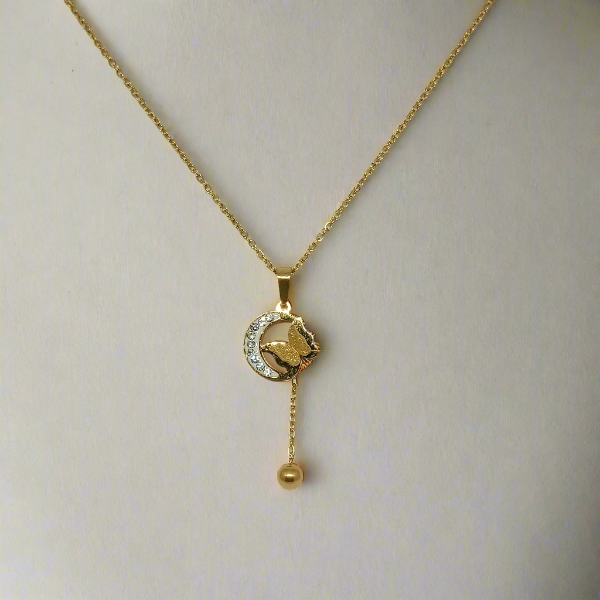 Gold necklace with a pendant on a light gray background