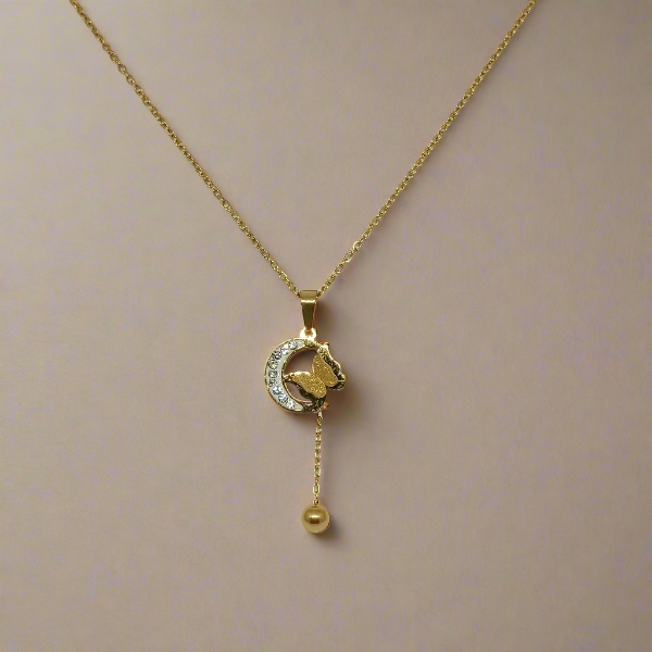 Gold necklace with a pendant on a beige background