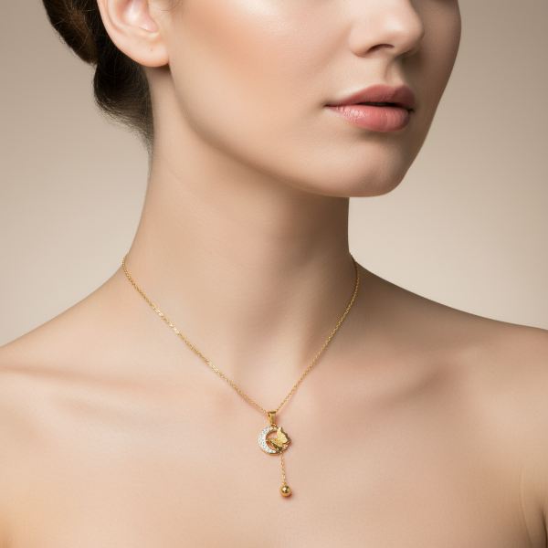 Golden necklace with a pendant on a model against a neutral background