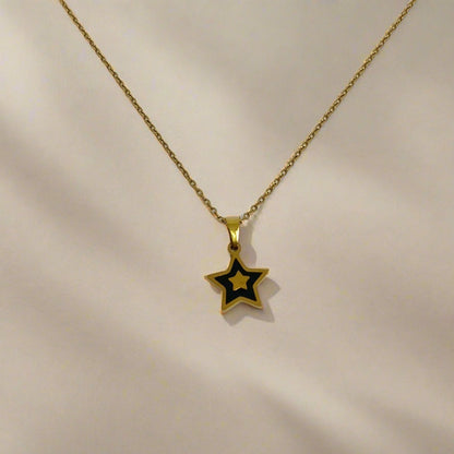 Gold star pendant necklace on a white card