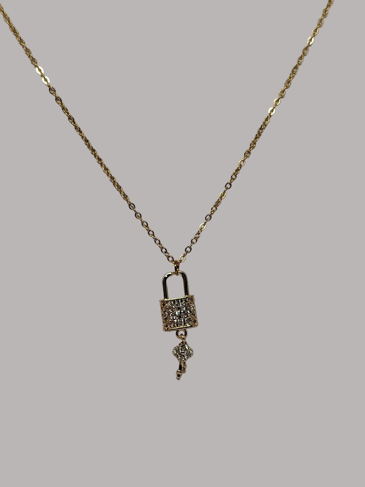 Gold necklace with a pendant on a white background
