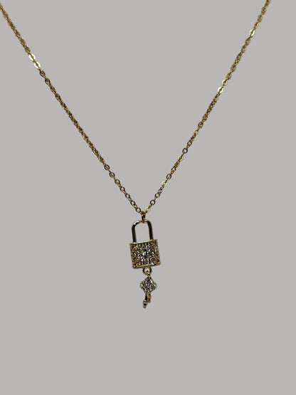 Gold necklace with a pendant on a white background