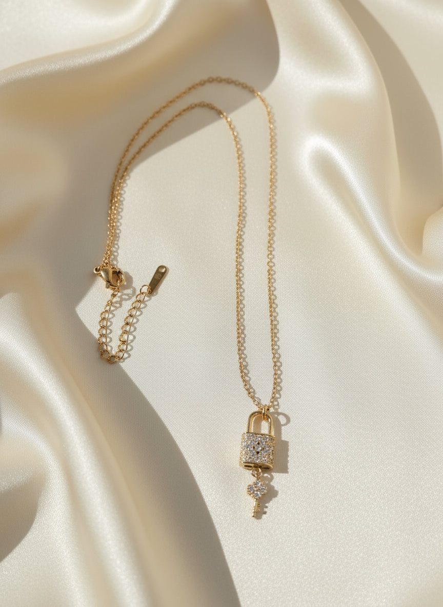 Gold necklace with a lock clasp on a silk background