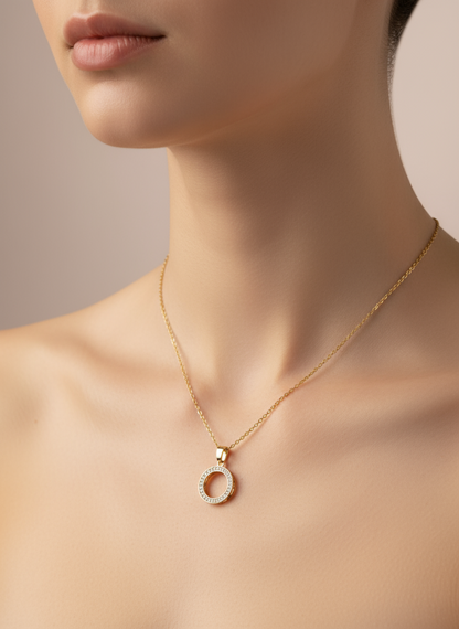 Golden necklace with a pendant on a model against a neutral background