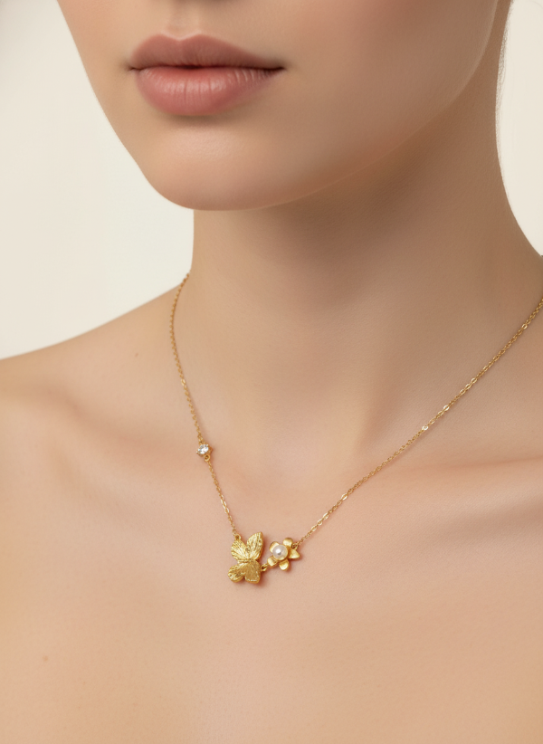 Golden necklace with a butterfly pendant on a neck