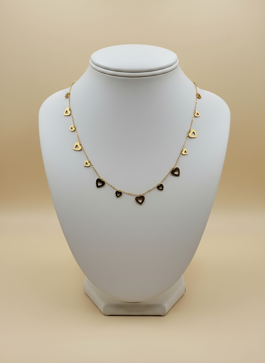 Necklace with heart-shaped pendants on a white mannequin bust against a beige background